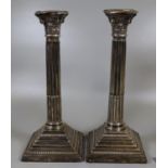 Pair of silver Corinthian column candlesticks on square stepped beaded bases, Birmingham