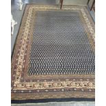 Middle Eastern design navy ground carpet. Overall with floral and geometric decoration 294x196cm