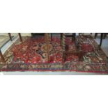 Middle Eastern design red ground carpet with central medallion of flower heads and having