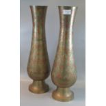 A pair of brass Indian tall vases decorated with multi-coloured flowers. (B.P. 21% + VAT)