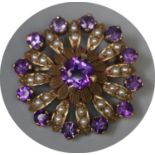A Victorian circle brooch set with amethyst and seed pearls. Diameter approx 27mm. Approx weight 5.8