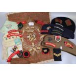 Collection of assorted military caps and berets, shoulder flashes and bands, souvenir embroidered