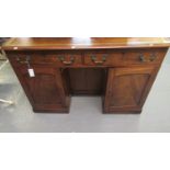 Victorian mahogany knee hole desk, the leather inset and moulded top above two drawers with brass