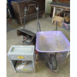 A garden wheelbarrow together with an Eltex greenhouse heater and a Mountfield lawn mower in very