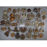 Biscuit tin containing a large collection of British military cap badges, various. (B.P. 21% + VAT)