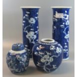 Pair of Chinese blue and white cylinder vases decorated with prunus blossom, together with similar