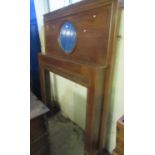 Early 20th century mahogany fire surround with circular bevelled mirror and strapwork banding. (B.P.