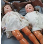 Two mid Century plastic dolls with movable limbs, together with a wooden toy sausage dog on wheels