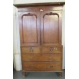 19th Century Welsh oak two stage press cupboard, the moulded cornice above two blind panelled doors,