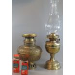 Early 20th Century double oil burner lamp with glass chimney and brass base. Together with another