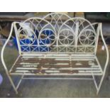 Weathered wrought iron garden two seater bench, the back with flower head and geometric