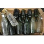 Box of glass bottles to include; dark green bottles marked 'Rogers Bristol', clear soda bottles