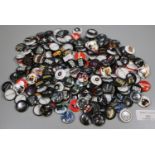 Plastic tub of assorted badges to include; Public Enemy, Motley Crew, The Strokes, The Wild Hearts