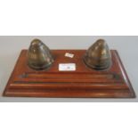 Trench art - oak pen tray set with two brass inkwells fashioned from the nose cones of large calibre
