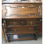 Early 20th century oak Jacobean style fall front bureau having two long drawers on barley twist