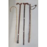 Four walking sticks to include; a very thin Charlie Chaplin type bamboo cane. (4) (B.P. 21% + VAT)