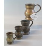 A group of four pot bellied brass baluster shaped measures, to include: 1/2 pint , a gill, 1/2