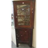 19th century oak astragal glazed corner cabinet, the interior revealing three shaped shelves. (B.