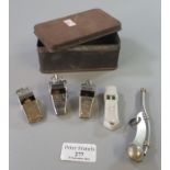 Vintage tin box comprising military bosun's silver plated whistle and other whistles marked '