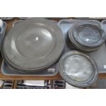 Two trays containing 18th/19th Century pewter plates and chargers, some with touch marks; 11