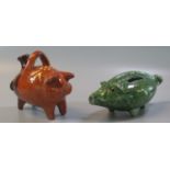 In the style of 'Ewenny', a green glazed pottery zoomorphic money box in the form of a pig, together