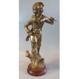 Brass figure of a striding boy with a basket of grapes over his shoulder on a naturalistic base with