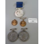 Two George V and Queen Mary Coronation medallions 1911, two Thomas Charles Welsh school medallions