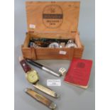 Wooden box comprising oddments to include; coins, fountain pens, gent's wristwatch, penknives