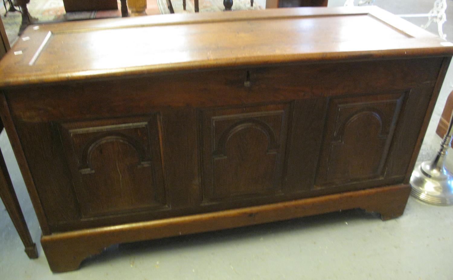 18th century oak coffer, the hinged lid revealing fitted candle box above three arch moulded and