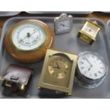 Three trays of miscellaneous items; quartz travel clocks, Sestrel porthole style alarm clock,