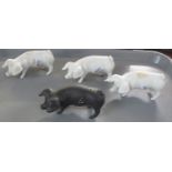 Tray containing four Royal Dux china pigs; three white and one black. With pink triangle and