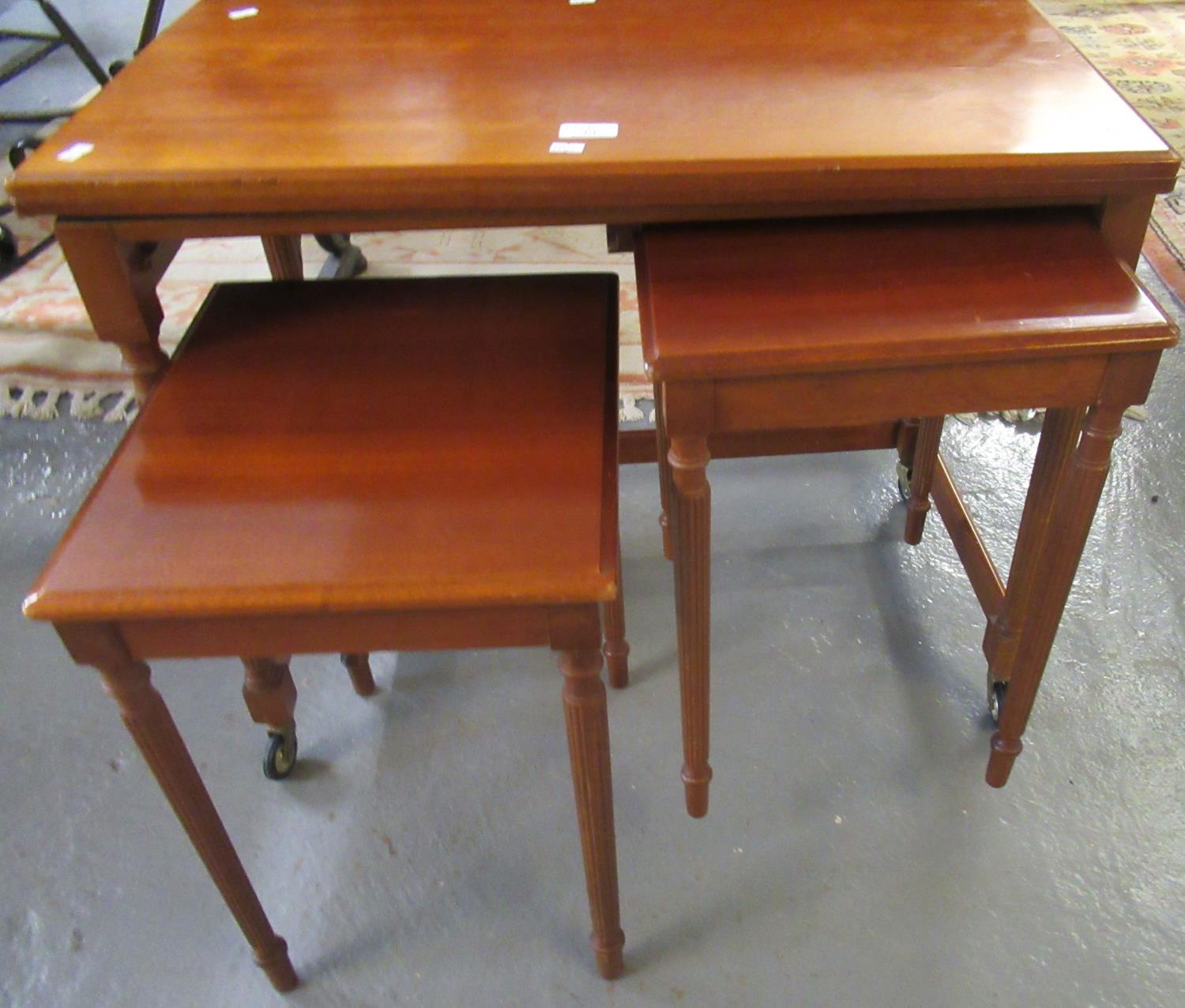 Reproduction mahogany finish swivel games/card table, with a nest of two tables on wheels. (B.P. 21%