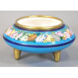 19th Century circular bowl on three gilded feet, the border raised with fruits and foliage,
