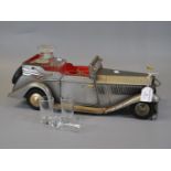 Novelty glass decanter set in the form of a metal Rolls-Royce car. (B.P. 21% + VAT)