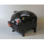 Vintage black ground pottery pig moneybox with hand painted decoration. (B.P. 21% + VAT)