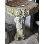 A garden weathered bird bath, the pedestal in the form of a tree stump. (B.P. 21% + VAT)