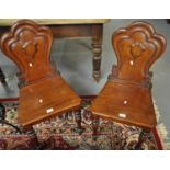 Pair of Victorian mahogany hall chairs having cloud back moulded design, shaped moulded seats