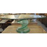 Unusual oval glass coffee table, the base with twisted step design. (B.P. 21% + VAT)