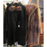 Two vintage fur coats: one brown and one black Astrakhan with 'Harella' and 'Astran, Paris'