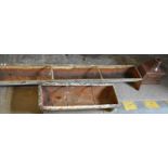 Cast iron feeding trough together with another galvanised feeding trough and a drain hopper