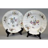 Pair of Meissen porcelain bowls overall hand painted with central floral sprays, the borders with