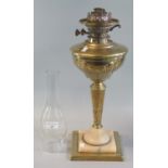 Early 20th Century double burner oil lamp, having brass reservoir on a brass and alabaster base. (
