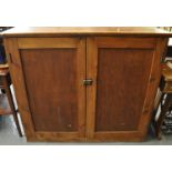 Early 20th century pine farmhouse blind panelled two door press type cupboard, the interior