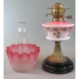 Early 20th Century double oil burner lamp having cranberry glass etched foliate shade, above an