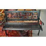 Painted and wooden cast iron two seater garden bench, the back decorated with pierced roses and