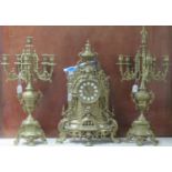 Victorian style brass clock garniture set, the two train clock with mask head and urn decoration,