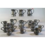 Collection of 17 antique pewter pot bellied jugs/tankards, gill measure, other measures measures
