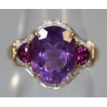 9ct gold ring set with purple stones and diamonds. Ring size N. Approx weight 3.4 grams. (B.P. 21% +
