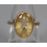 9ct gold dress ring set with an oval yellow stone. Ring size M. Approx weight 3.9 grams. (B.P. 21% +