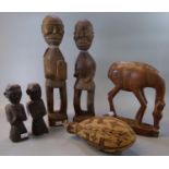 Group of African or Eastern carvings, to include: two pairs of figures, a grazing antelope and a